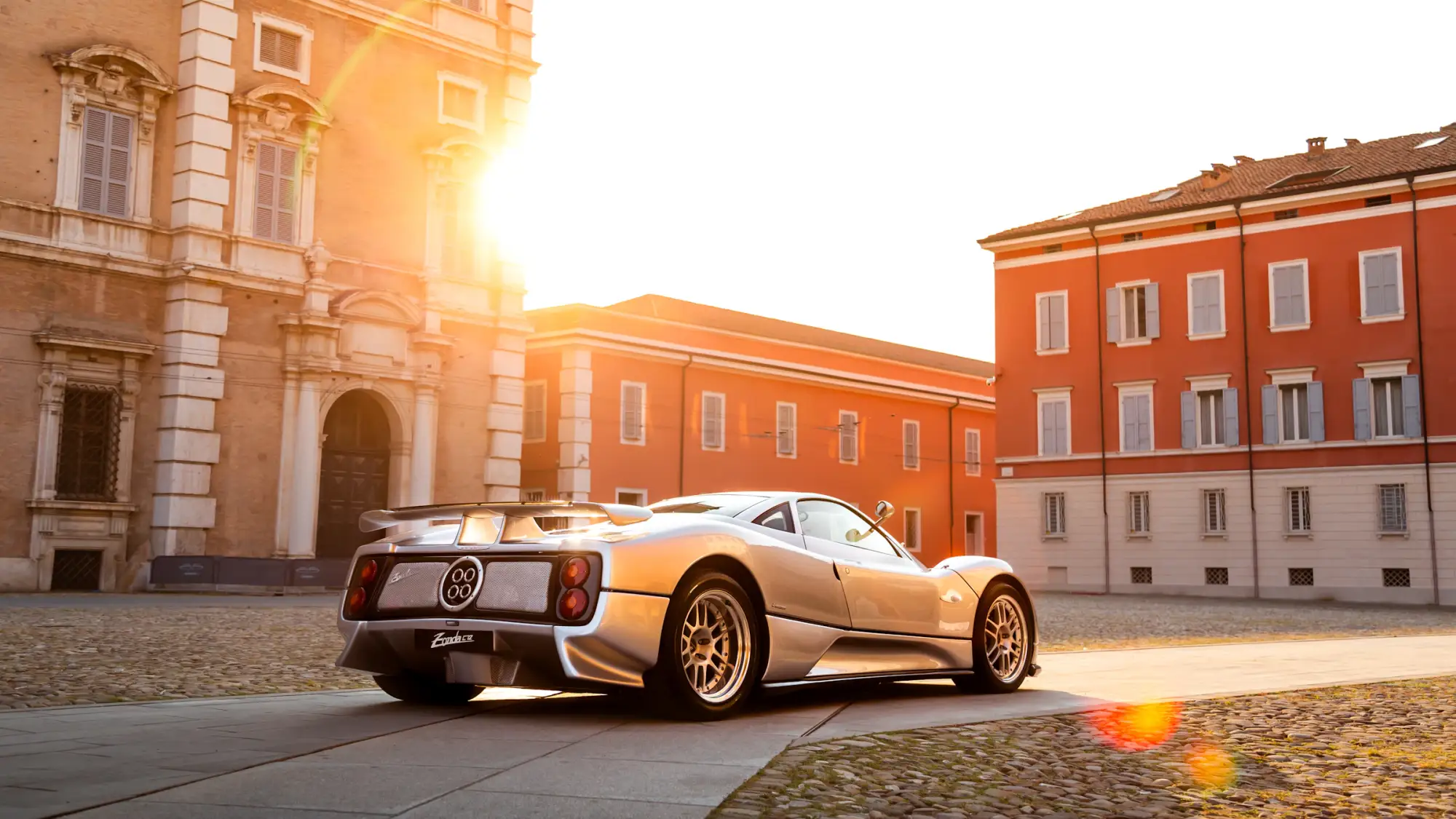 Silver Pagani Zonda in a sunlit square in Modena