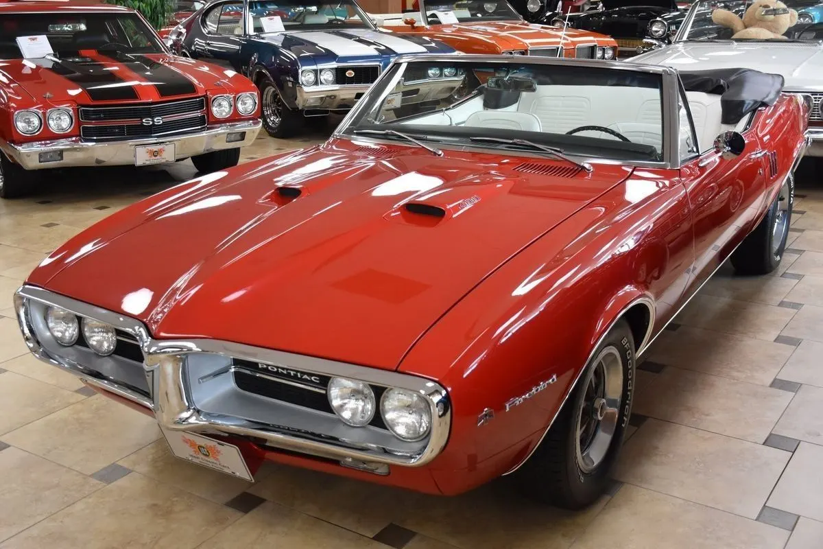 Red Pontiac Firebird convertible in a showroom
