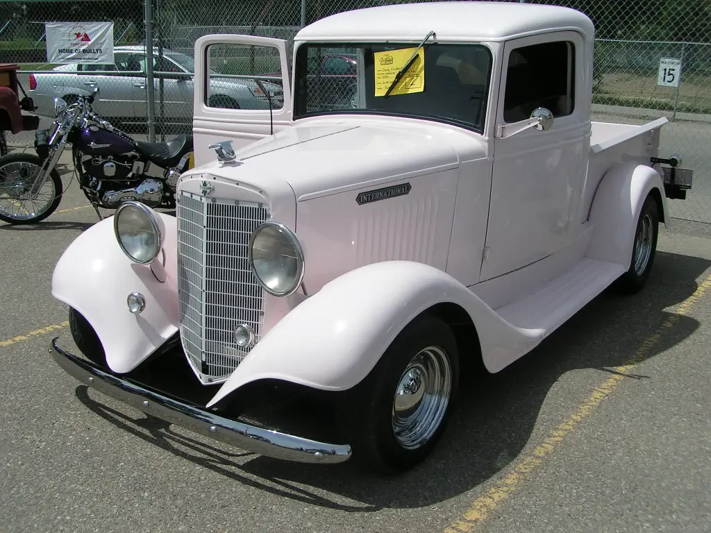 Pale pink restored 1934 International pickup truck with a chrome grille