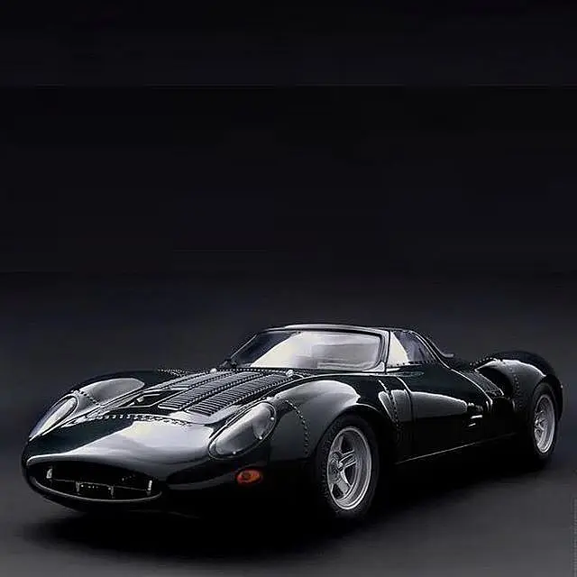 Black retro coupe in a dark studio