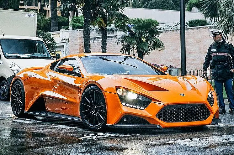 Orange Zenvo ST1 on a wet street