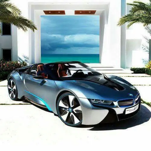Silver and blue BMW i8 Roadster in front of a white villa, second photo