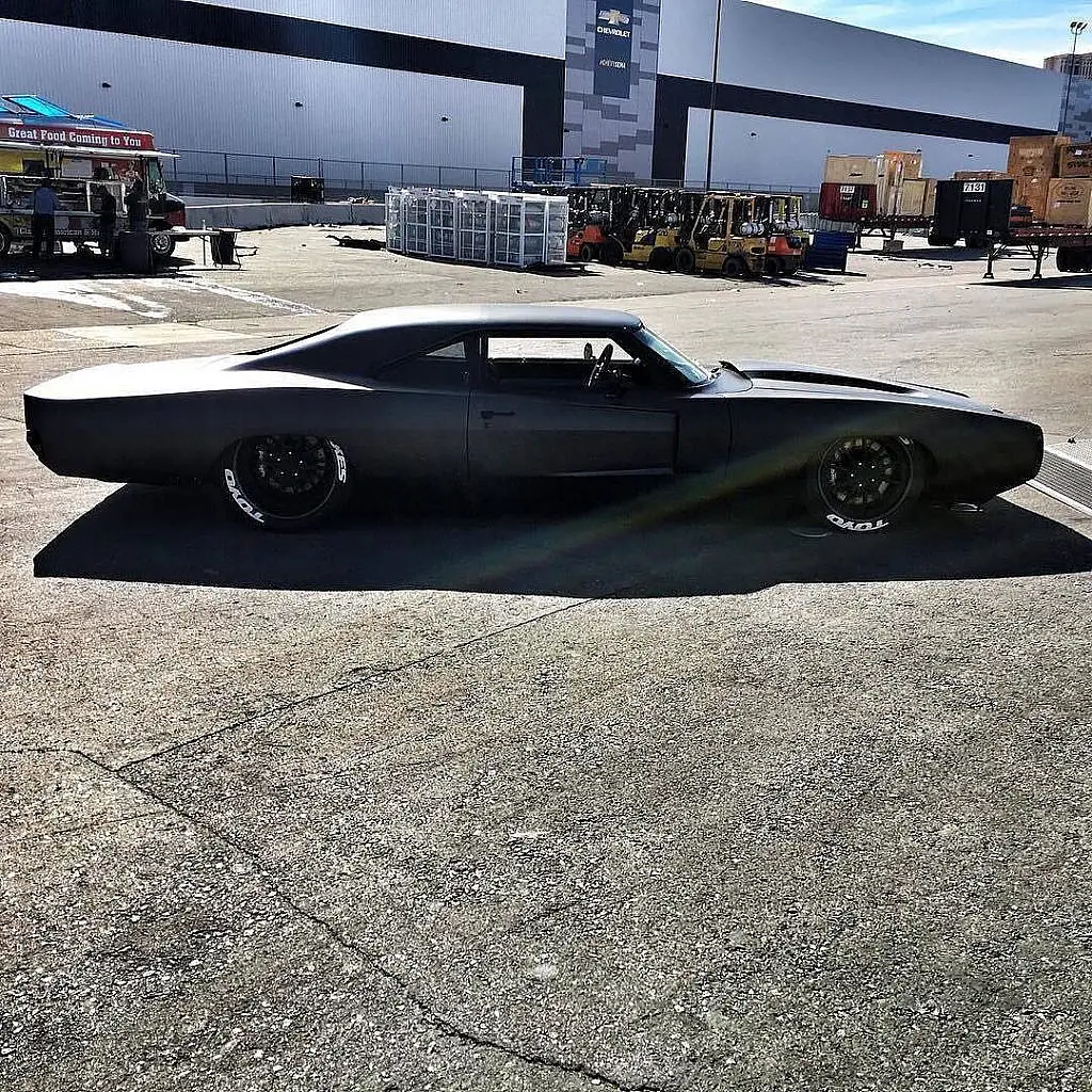 Matte black low-slung muscle car in profile