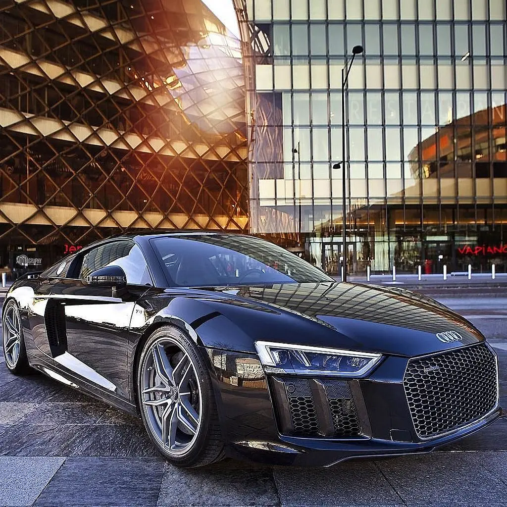 Black Audi R8 V10 in front of a glass building