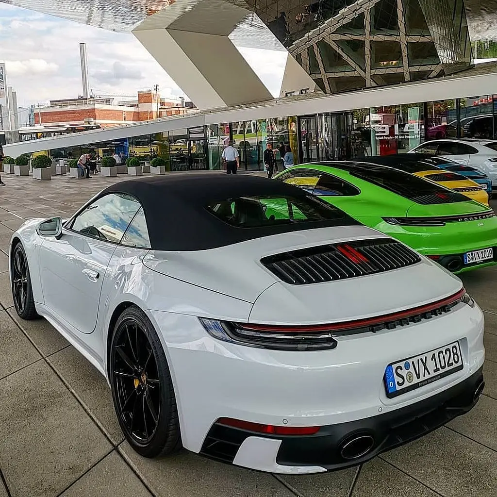 White Porsche 911 Cabriolet from behind at a Porsche centre