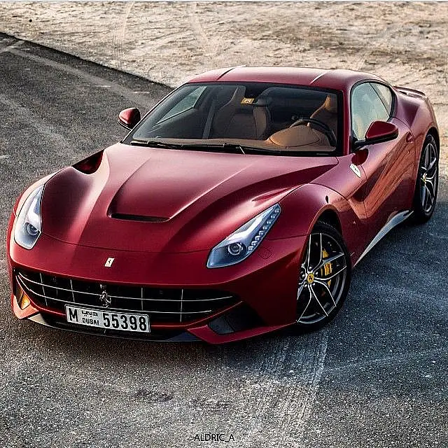 Dark red Ferrari F12 Berlinetta on a road