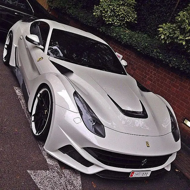 White widebody Ferrari F12 on a brick street