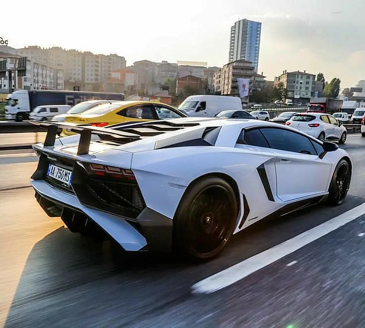 White Lamborghini Aventador SV in motion in a city street