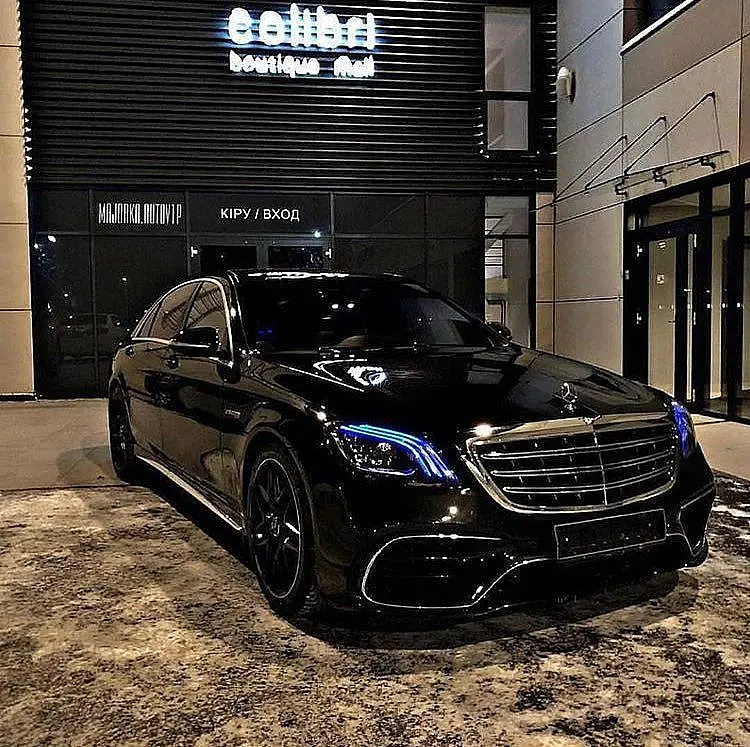 Black Mercedes-Benz S-Class in front of a boutique