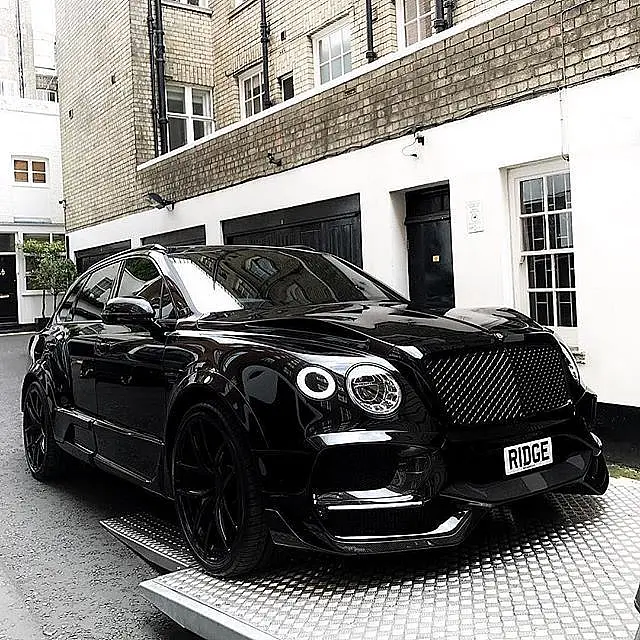 Black Bentley Bentayga in a mews