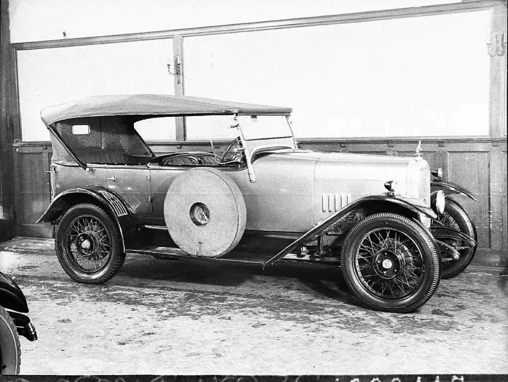 Black and white period photograph of a 1926 Alvis 12/50 four-seat tourer with the hood up