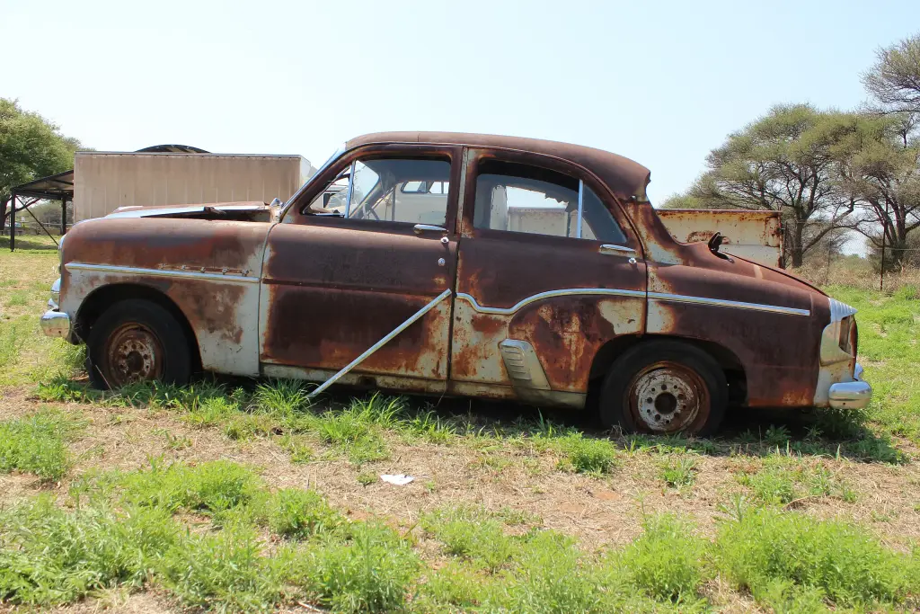 Old rusted Vauxhall Wyvern classic car at Bonnington Farm